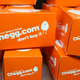 A pile of orange boxes with the logo for Chegg.com on them.